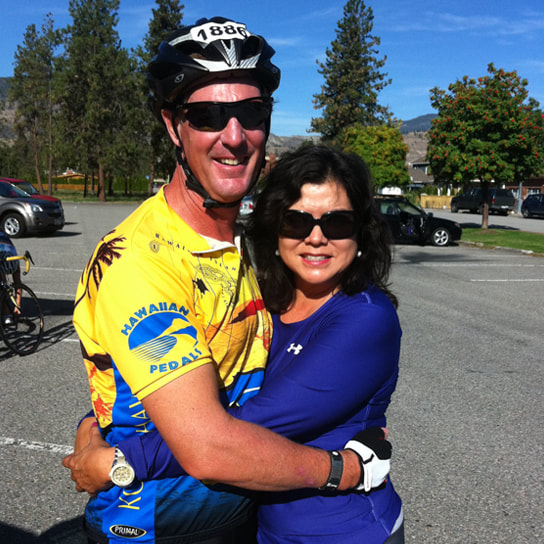 Big Island Realtor Diana Mahaney and her husband, who is wearing a bicycle helmet and appears to be participating in a race / competition