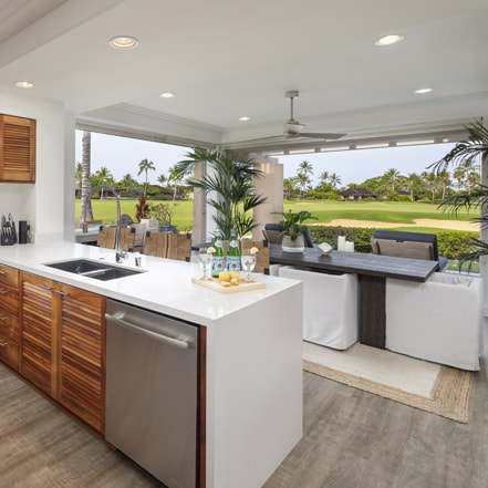 Luxury rental of kitchen and living room opened to outside and golf course views, provided by Big Island Realtor Diana Mahaney